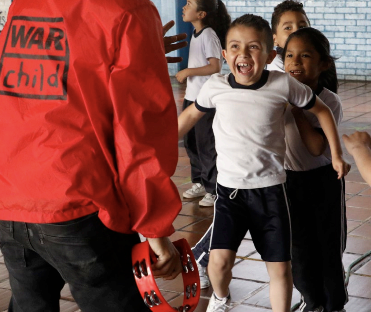 Children in a school hall during a group activity
