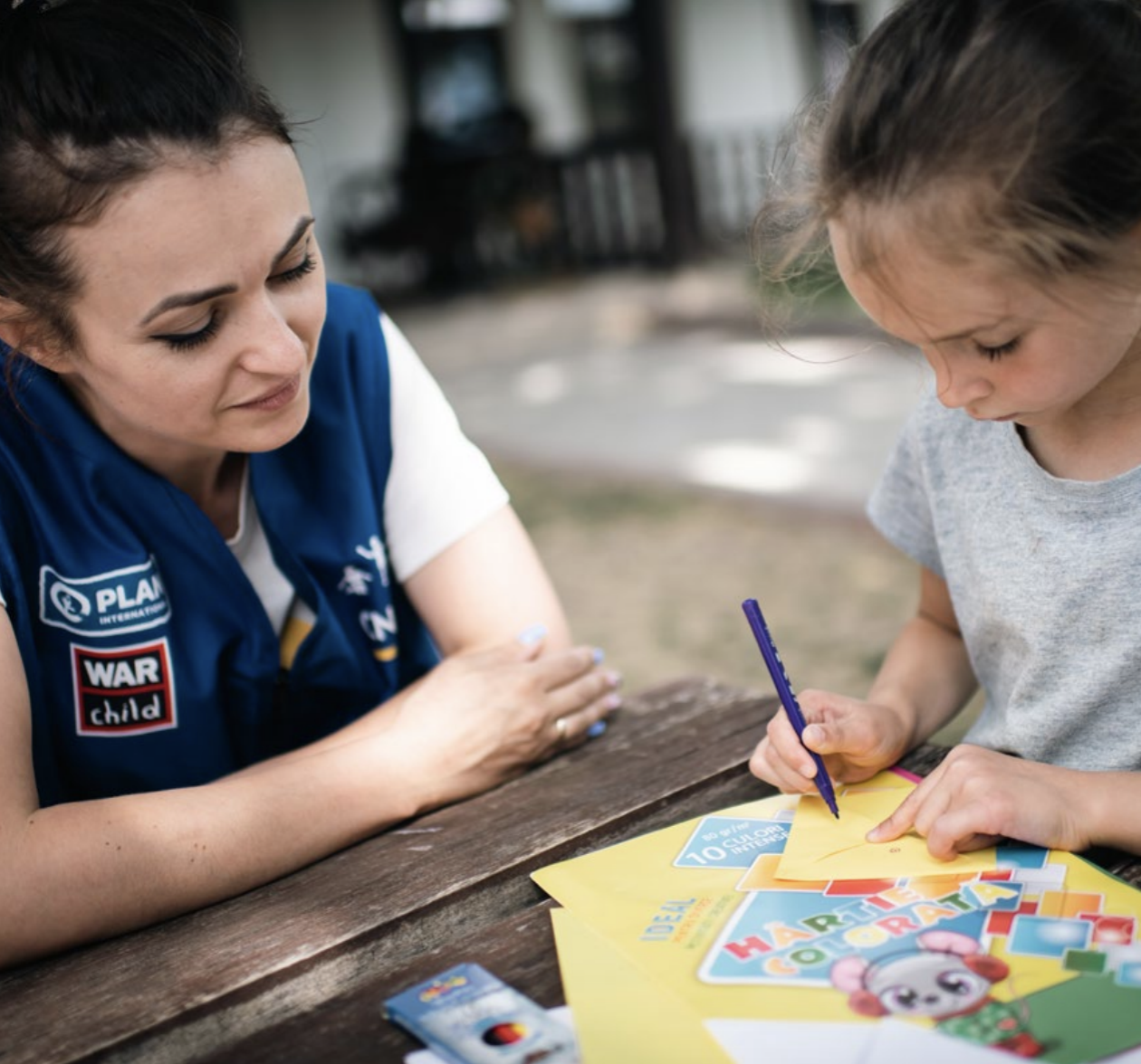 Facilitator working one-to-one with a child